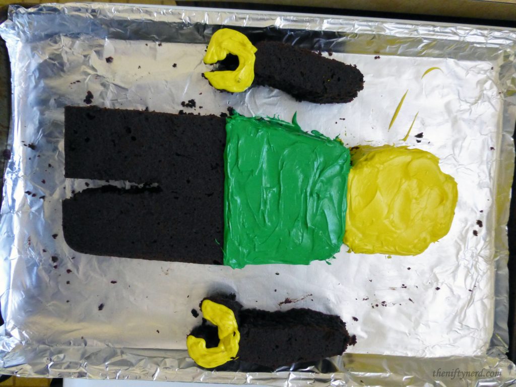frosting a Lego cake man