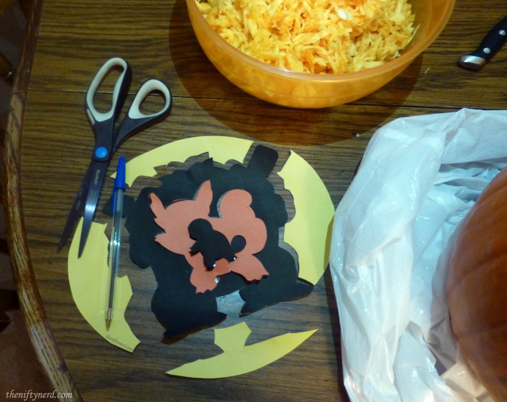 Cutting out a pokemon pumpkin carving template