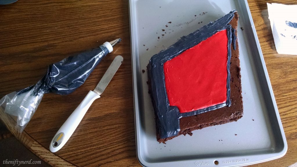 Frosting the diamond shaped Horde crest cake