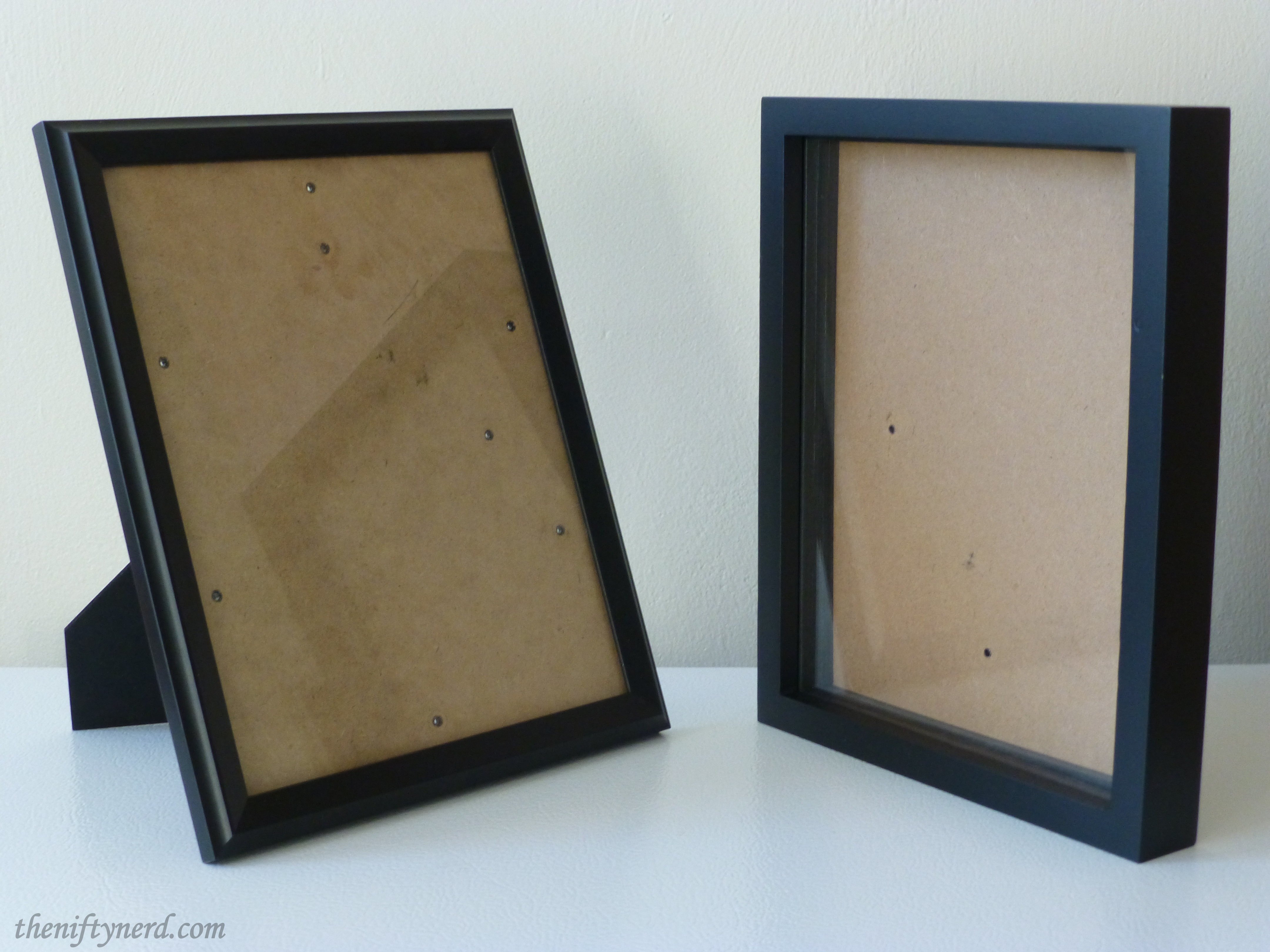 empty black picture frame and shadow box