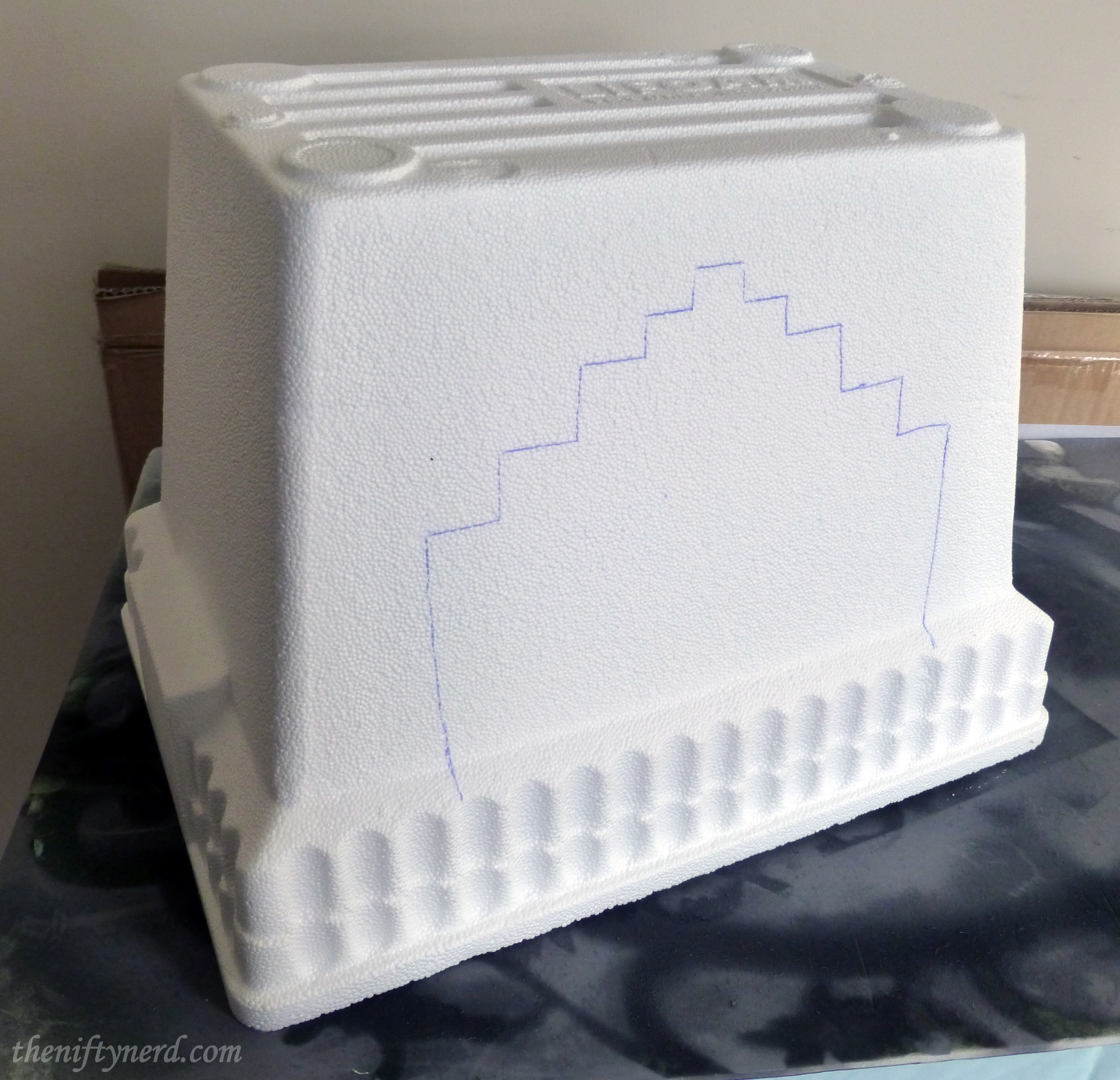 tracing the legs on a foam cooler