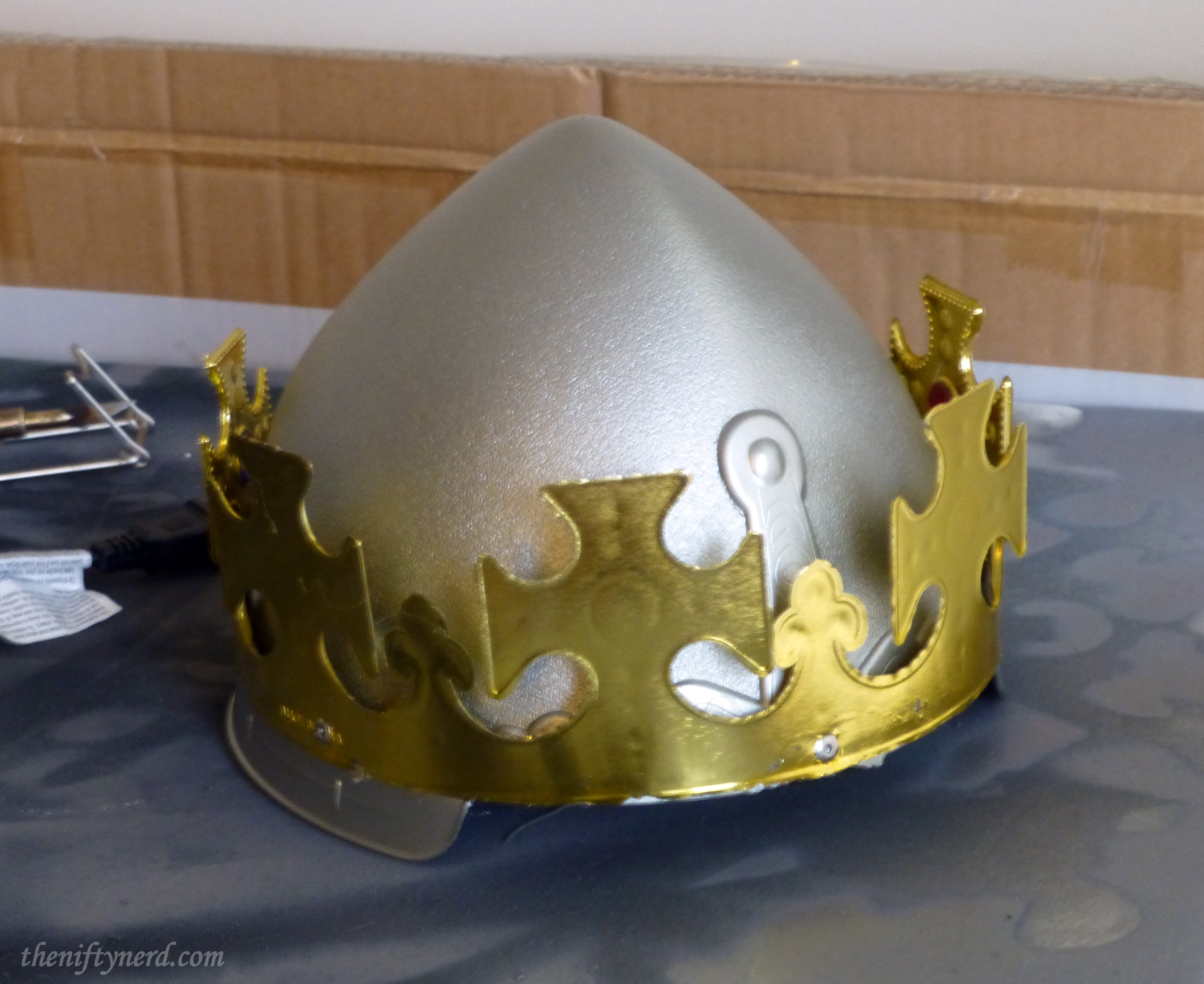 rivetting the crown to the helmet